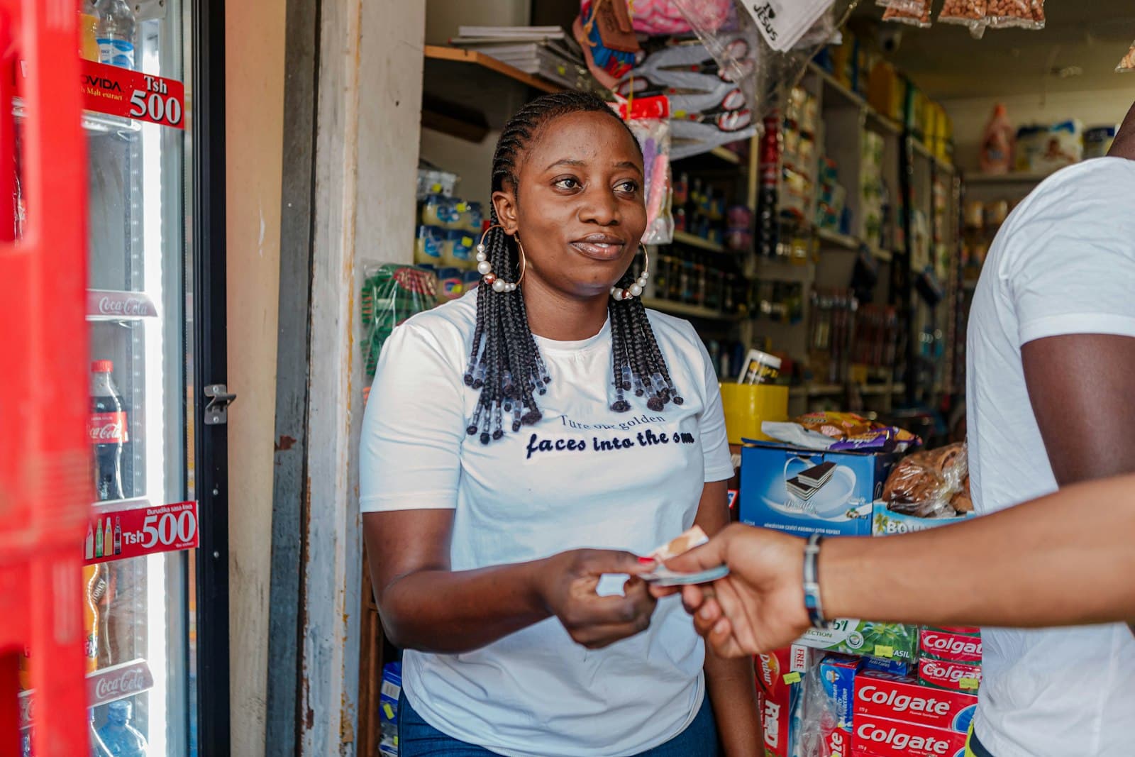 A shopkeeper taking payment from a customer