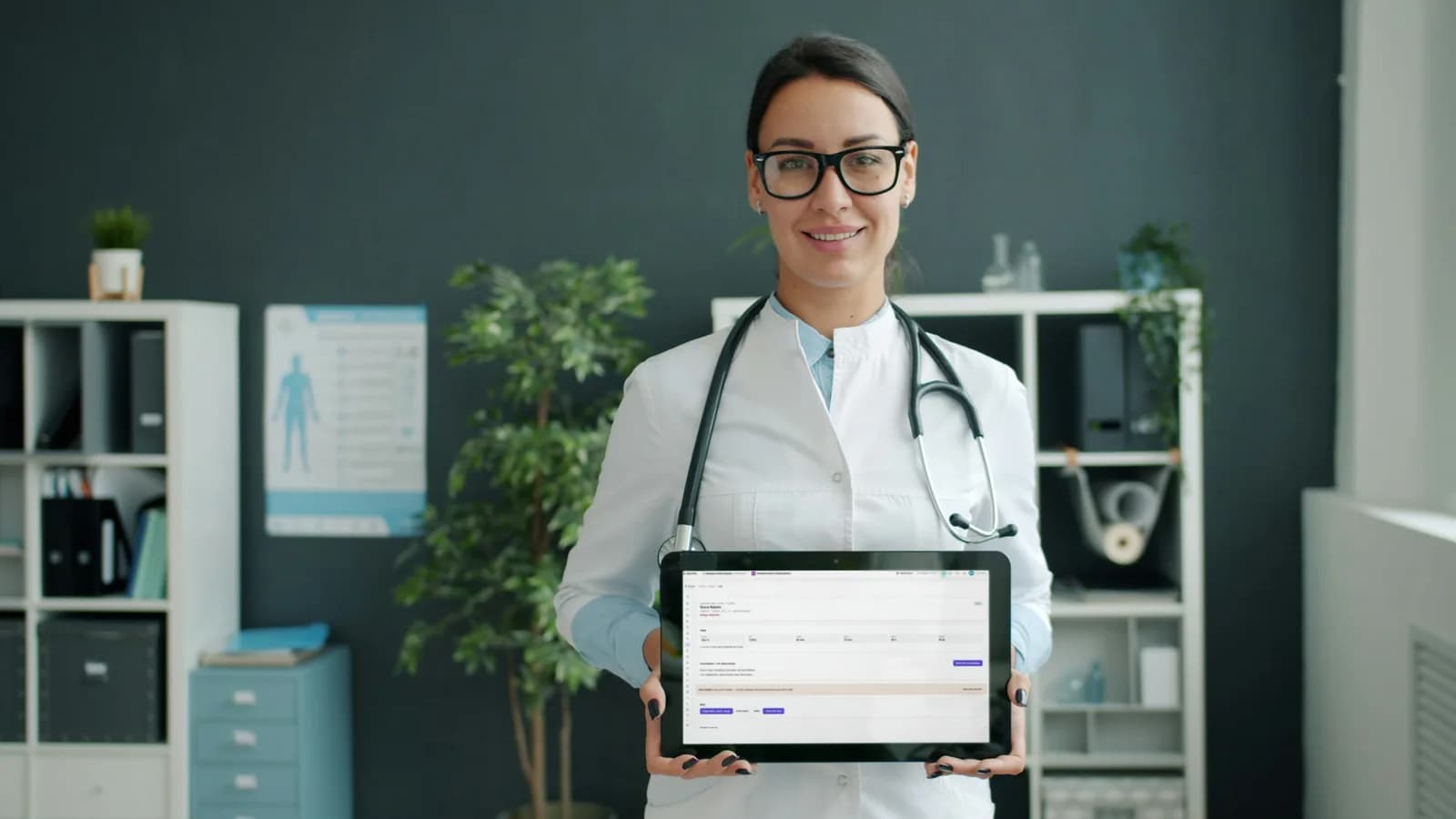 A doctor holding a tablet with the clinic queue